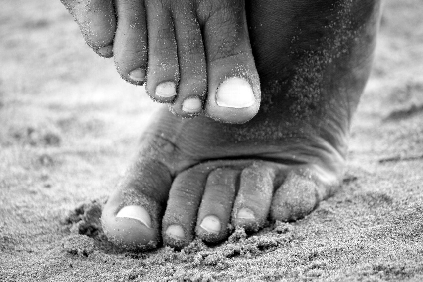 Black and White Detail of Feet on Sand